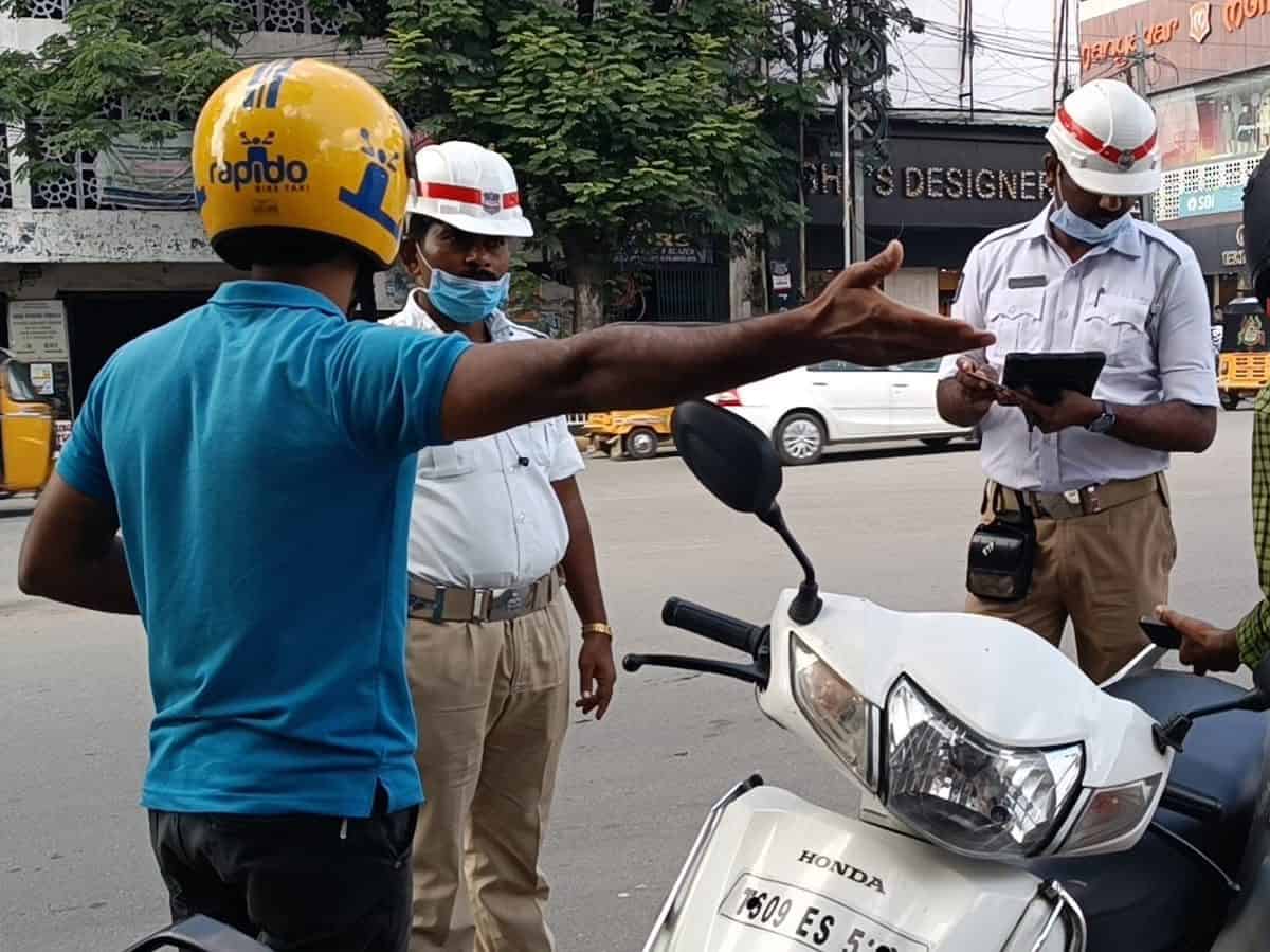 Driving  a vehicle while using earphones or headsets, you will be fined 20,000 rupees